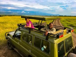 Safari vehicle watching elephants in Queen Elizabeth National Park on a Uganda Rwanda Safari