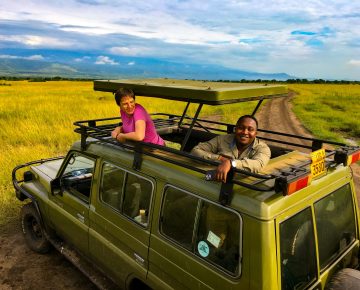 Safari vehicle watching elephants in Queen Elizabeth National Park on a Uganda Rwanda Safari