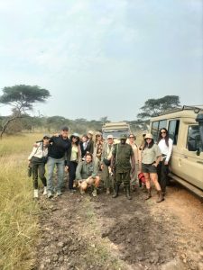 Small group of tourists on Uganda safari in open-roof vehicle