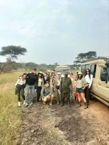Small group of tourists on Uganda safari in open-roof vehicle
