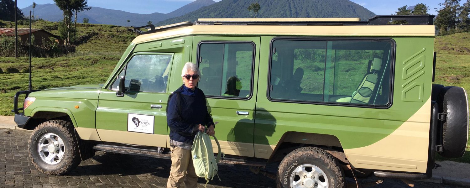Tourists trekking golden monkeys in Volcanoes National Park. Rwanda luxury Safari
