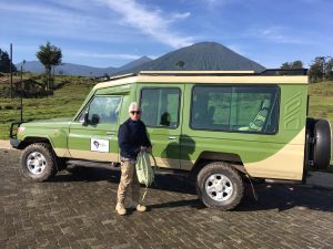 Tourists trekking golden monkeys in Volcanoes National Park. Rwanda luxury Safari