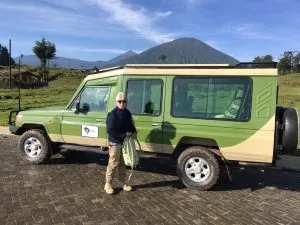 Tourists trekking golden monkeys in Volcanoes National Park. Rwanda luxury Safari