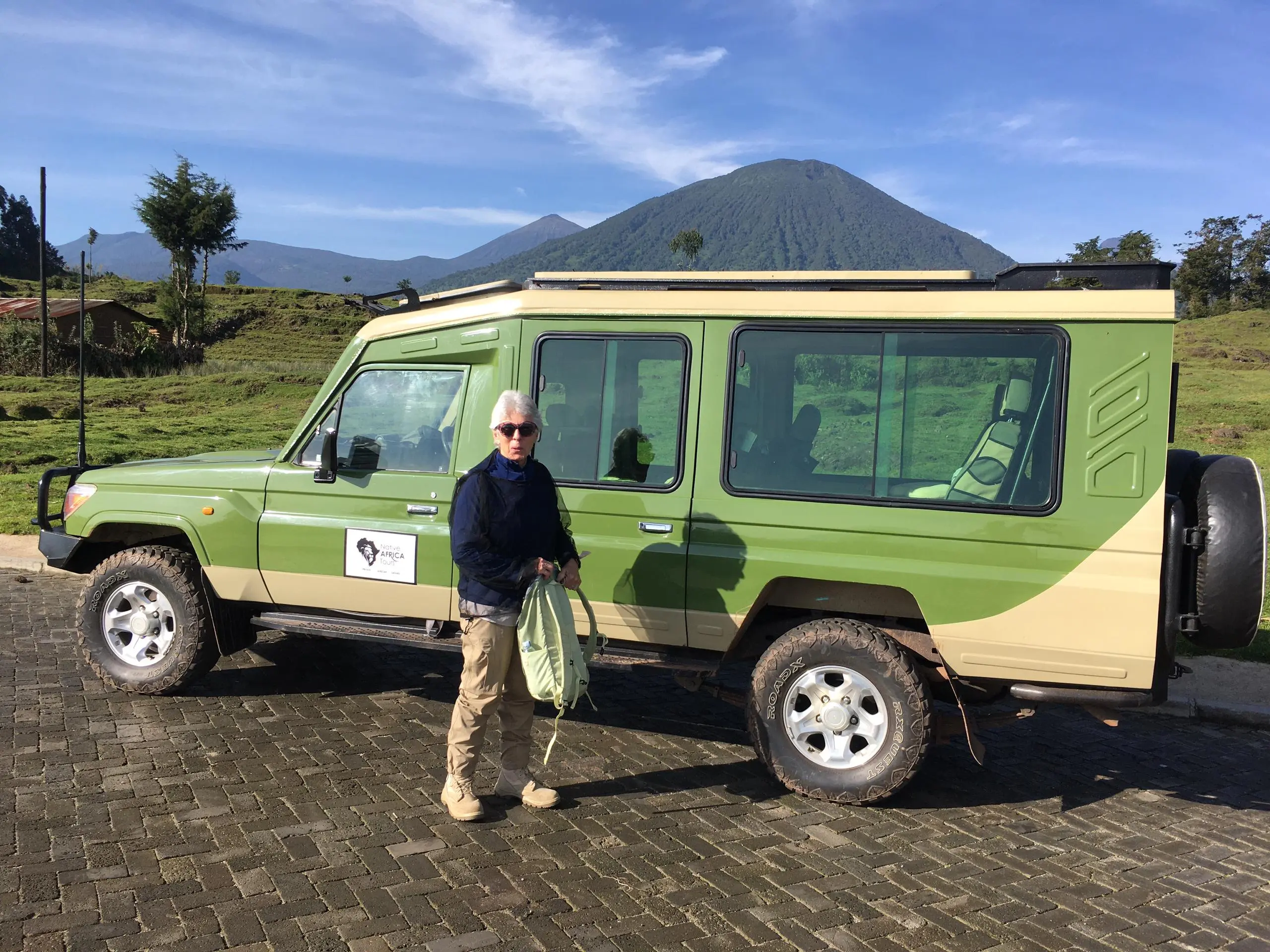 Tourists trekking golden monkeys in Volcanoes National Park. Rwanda luxury Safari