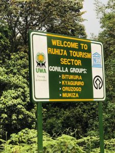 Bwindi Impenetrable National Park entrance gate with visitors paying park fees