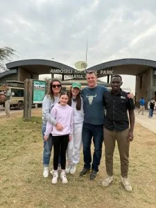 Tourists pausing for a photo at Amboseli National Park Kimana Gate in June Kenya safari