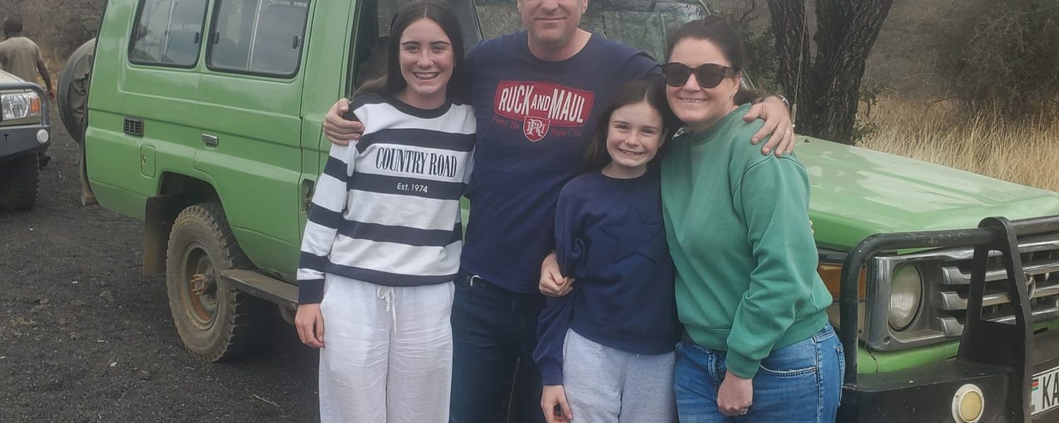 Tourists on a Kenya safari Land Cruiser during April rainy season adventure