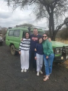 Tourists on a Kenya safari Land Cruiser during April rainy season adventure