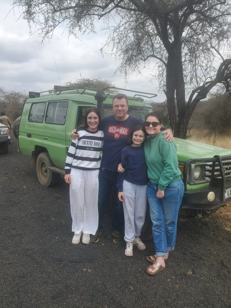 Tourists on a Kenya safari Land Cruiser during April rainy season adventure