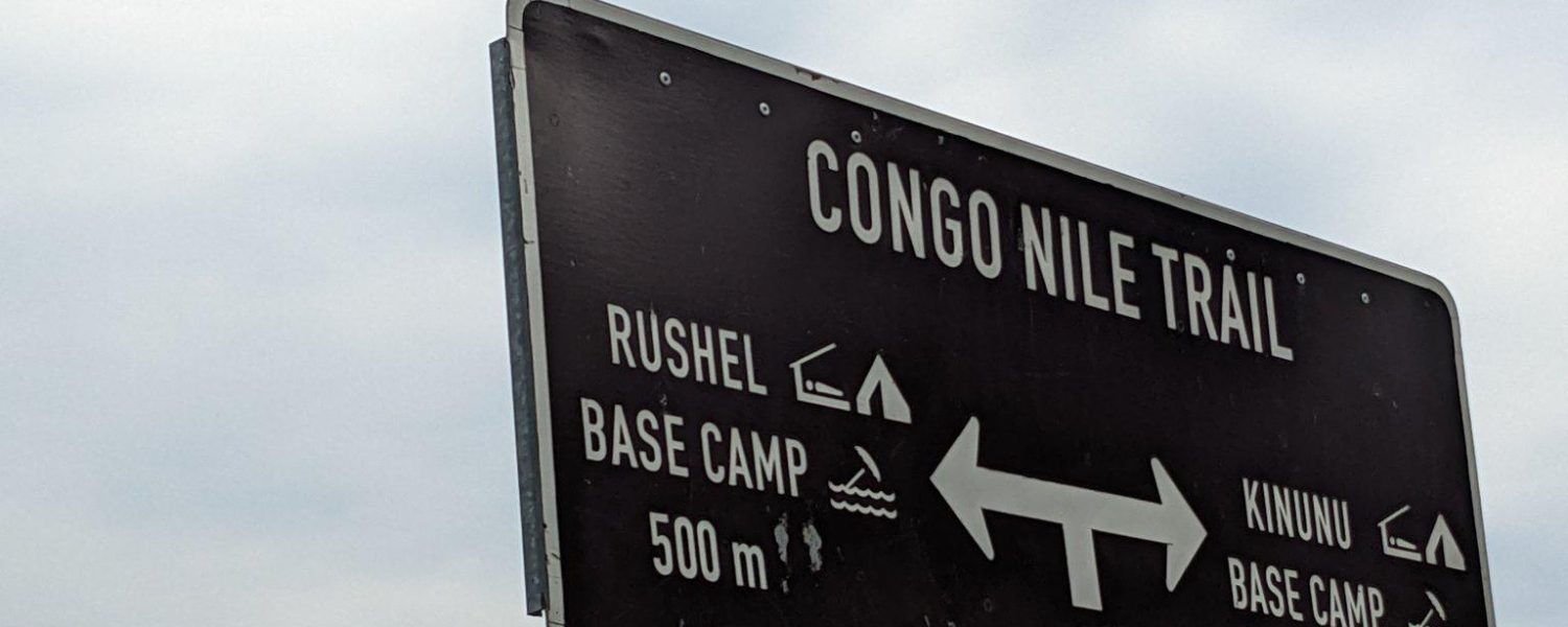 A sign post of the Congo Nile Trail on Lake Kivu