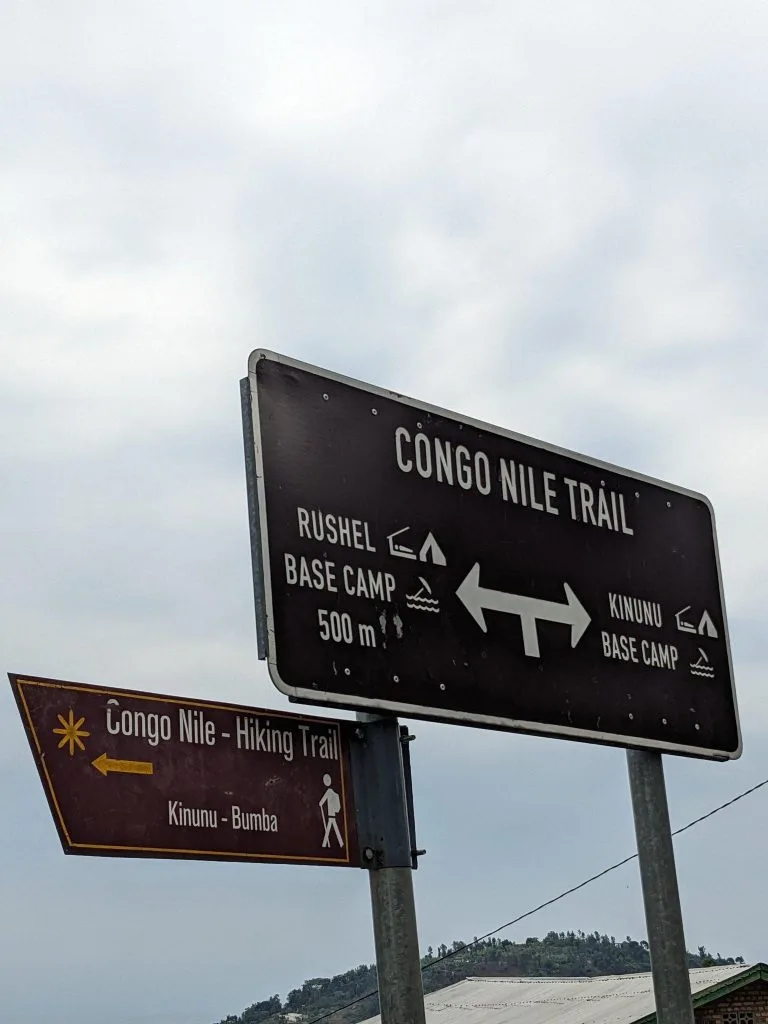A sign post of the Congo Nile Trail on Lake Kivu