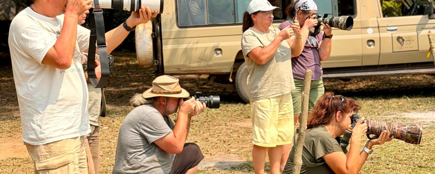 Guests taking a photo of a Hippo while on a Birding and Wildlife safari with Native Africa Tours