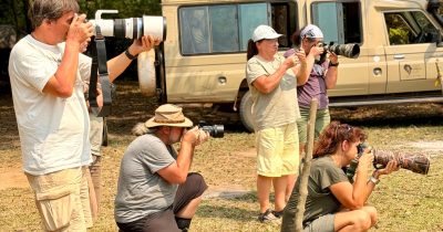 Guests taking a photo of a Hippo while on a Birding and Wildlife safari with Native Africa Tours
