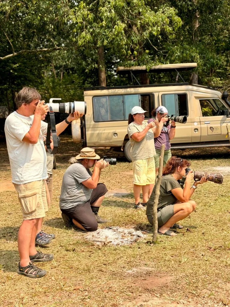 Guests taking a photo of a Hippo while on a Birding and Wildlife safari with Native Africa Tours