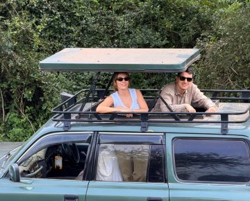 A couple in our Open roof jeep in Lake Mburo National Park while on Day 4 of their Uganda Trip that started from Kigali Rwanda